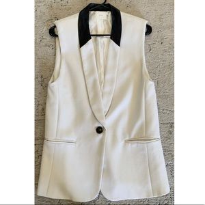 Lush white sleeveless blazer with black leather collar. Size small